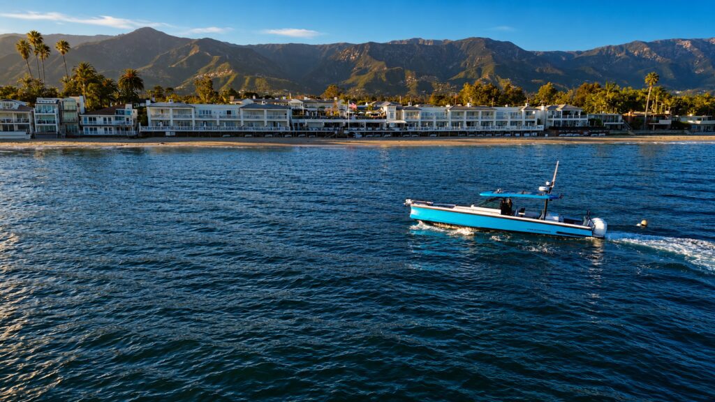 Riptide charter boat cruising the Santa Barbara coastline at golden hour